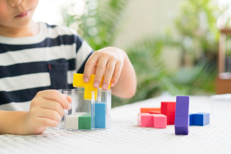 Closeup,Of,A,Little,Boy's,Hands,Playing,Colorful,Block,Puzzles,