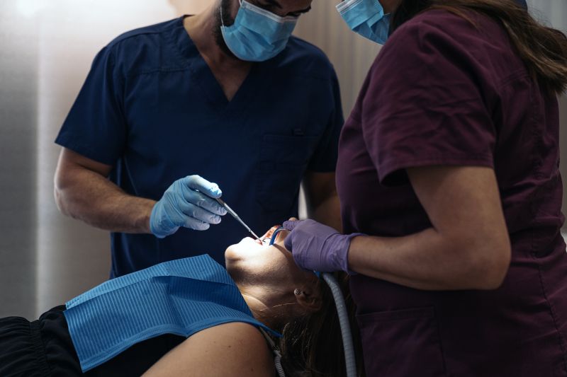 Stock photo of unrecognized woman in the dentist with her mouth open.